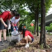 Students join migrant workers for annual beach clean-up